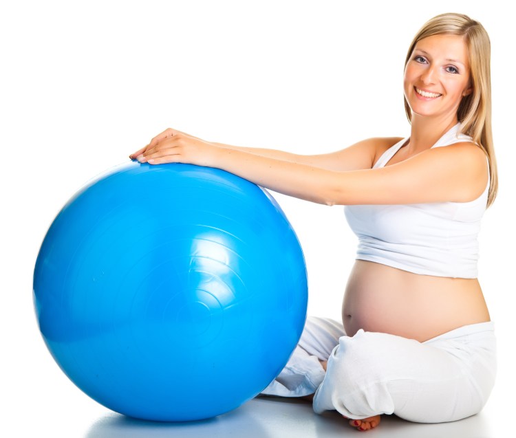 Pregnant woman excercises with gymnastic ball