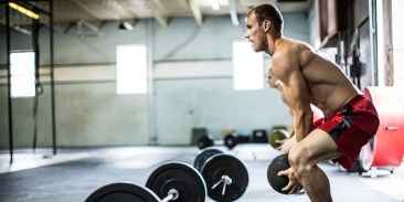 man doing cross fit medicine ball slams